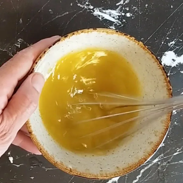 salad dressing whisked in a small bowl.