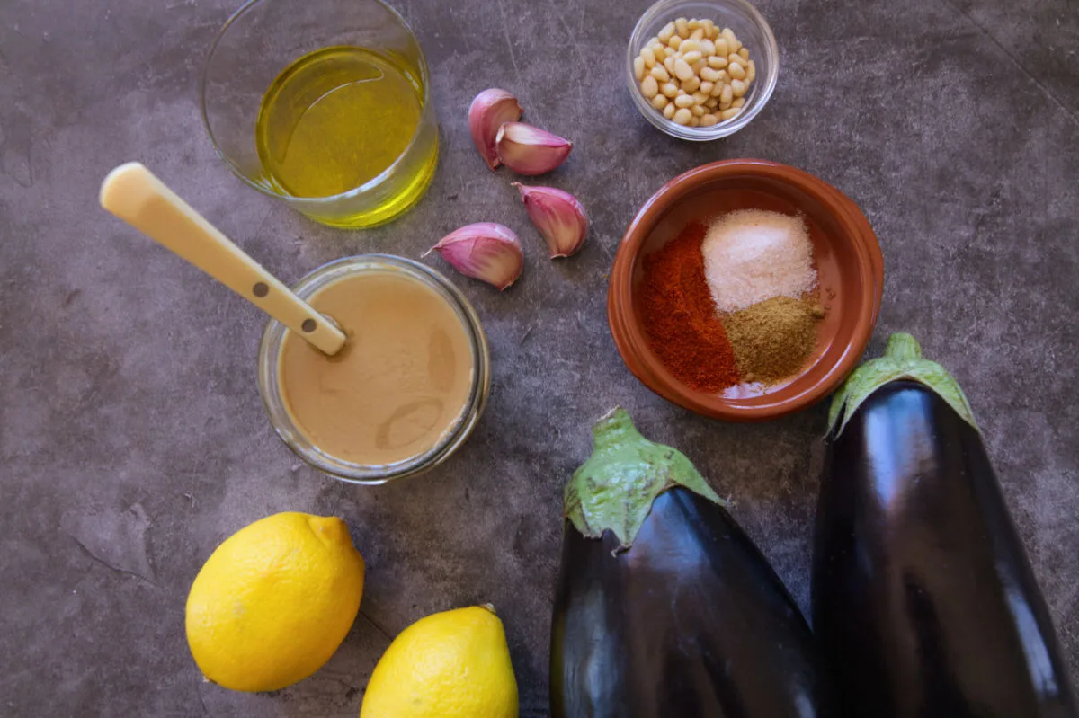 Ingredients used to make baba ganoush are laid out on a table. 