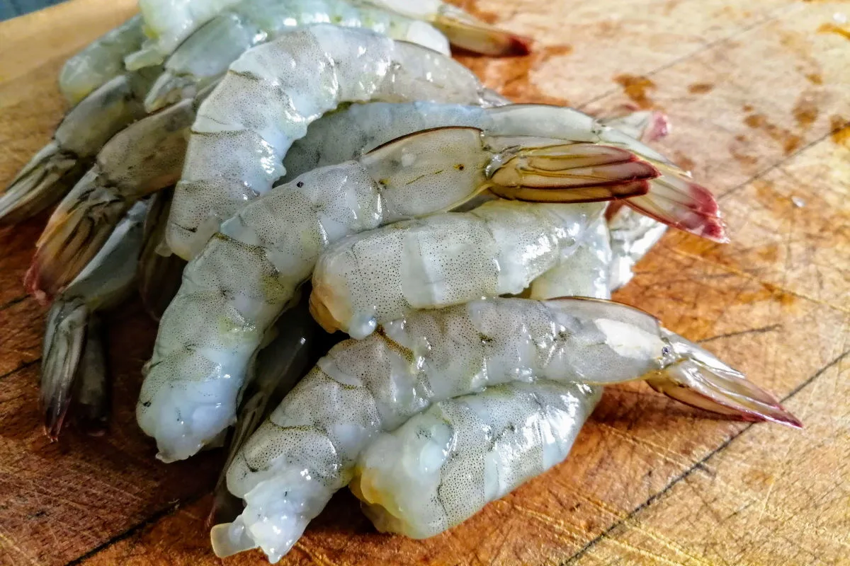 Peeled raw shrimp with their tails still attached