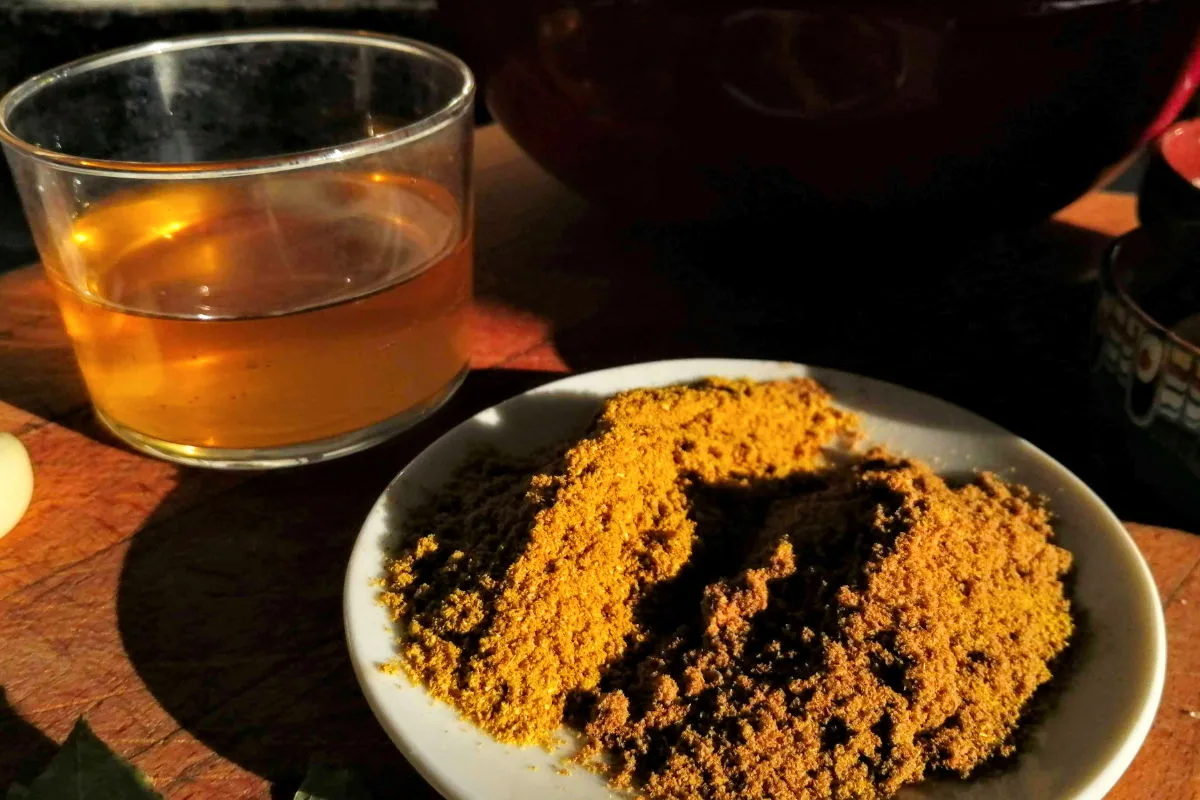 Spices on a plate with some vinegar in the background