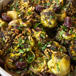 A large dish of Za'atar with roasted eggplant, leek, and artichoke hearts.