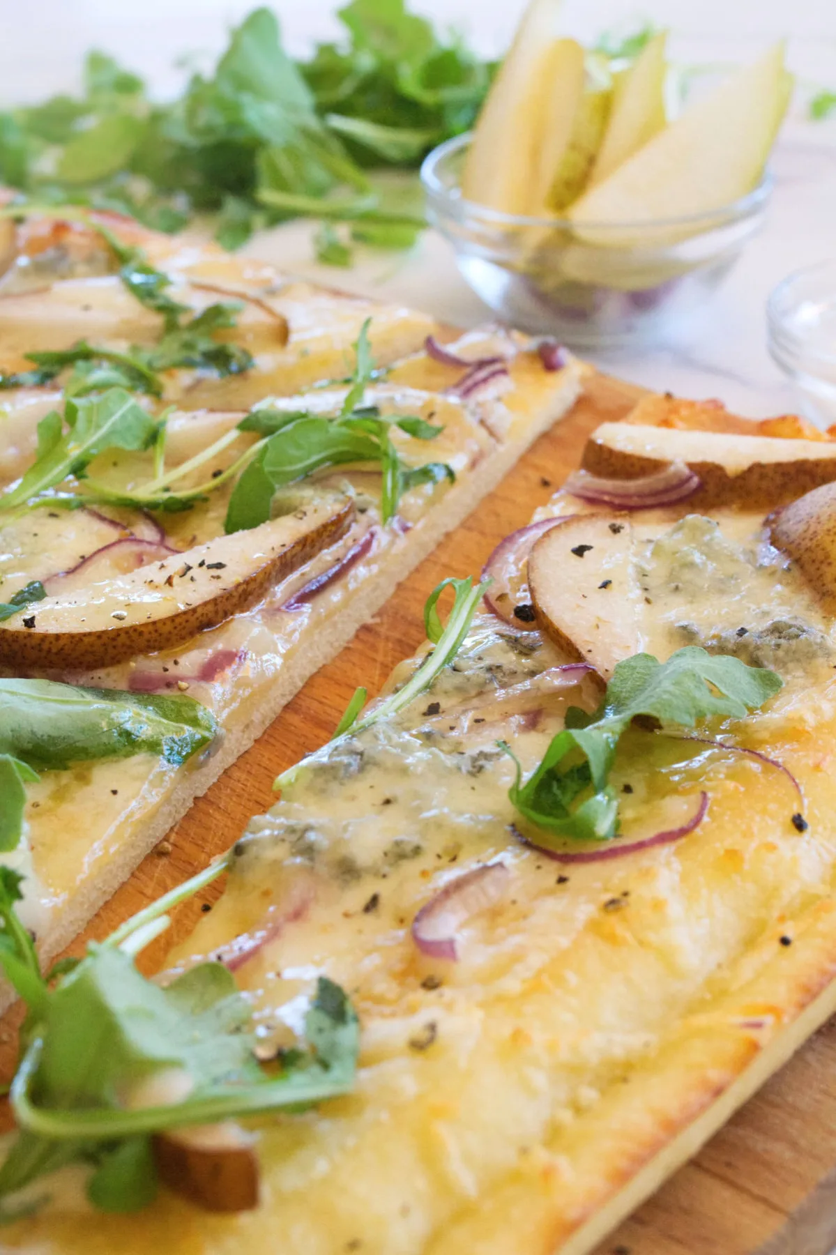 slices of Gorgonzola pizza topped with rocket.
