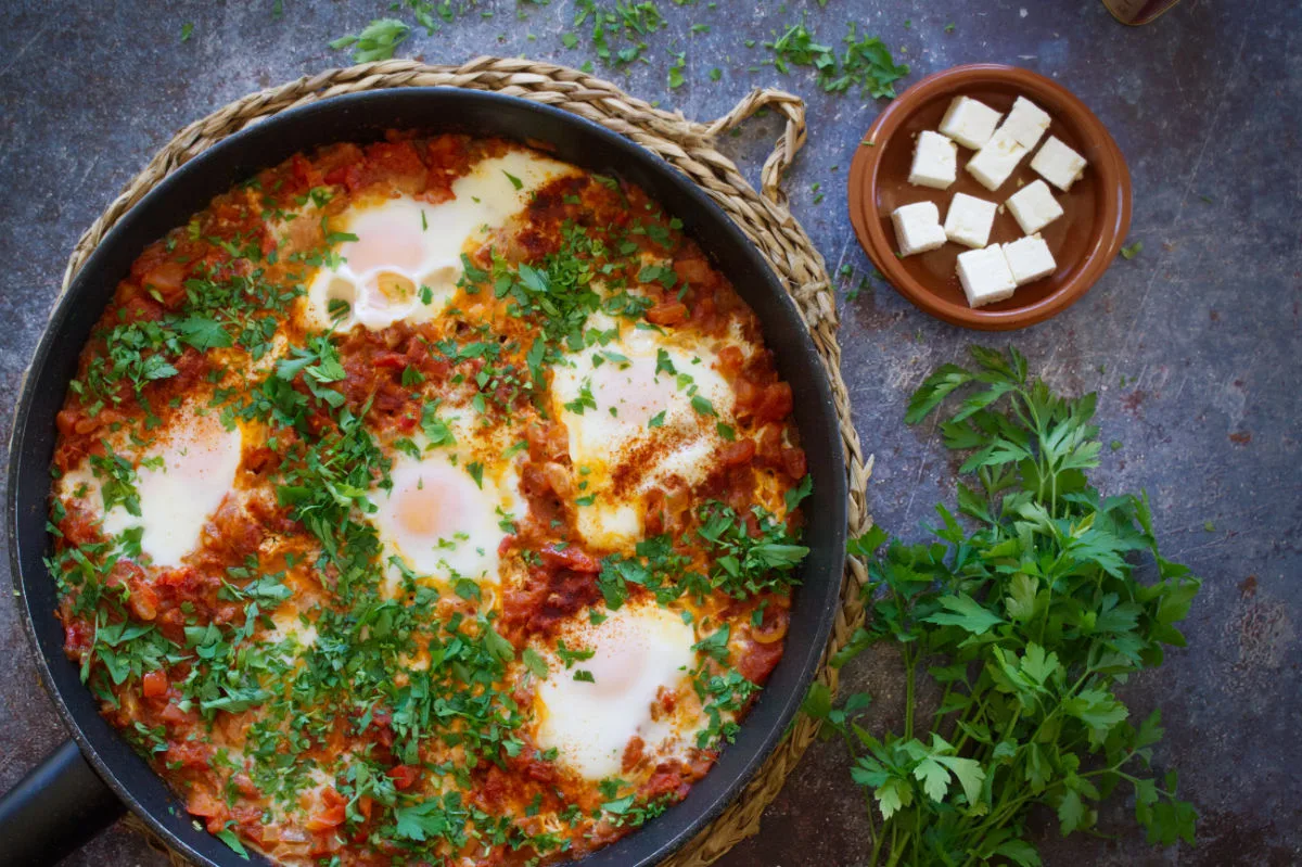 A large pan of Shakshuka with eggs poached on top.