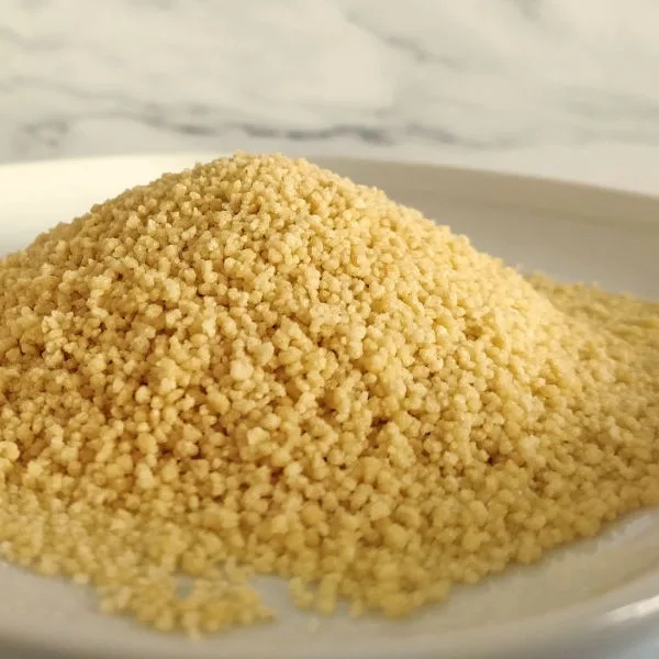 A pile of uncooked couscous on a plate