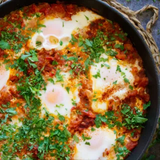 A large pan of Shakshuka with eggs poached on top.