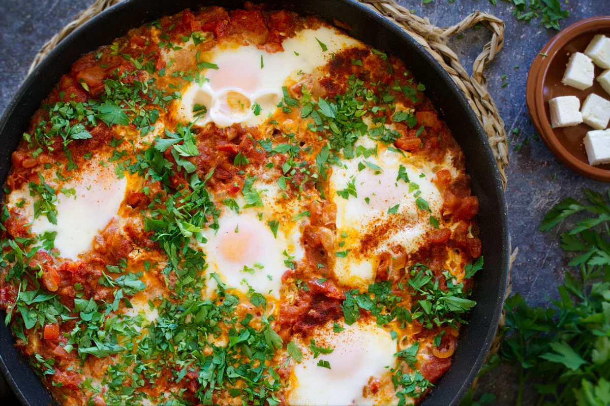 A large pan of Shakshuka with eggs poached on top.