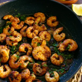 Spanish garlic shrimp cooked and served in a skillet.
