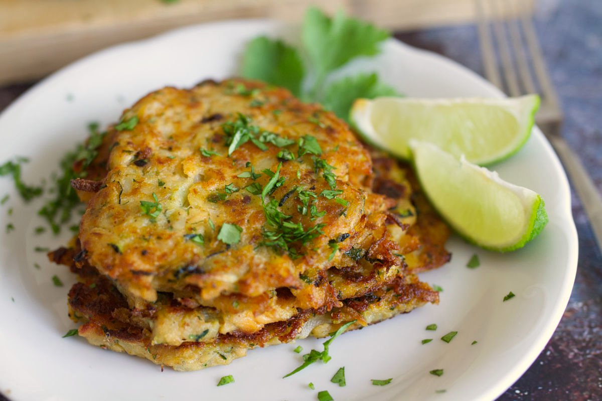 A stack of salmon fishcakes with cilantro and lime.