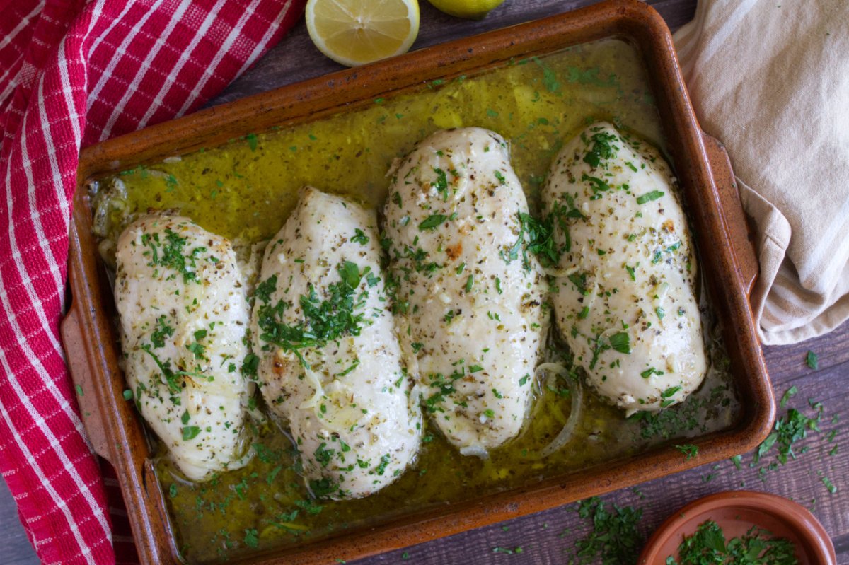 Mediterranean chicken breasts in a casserole dish.