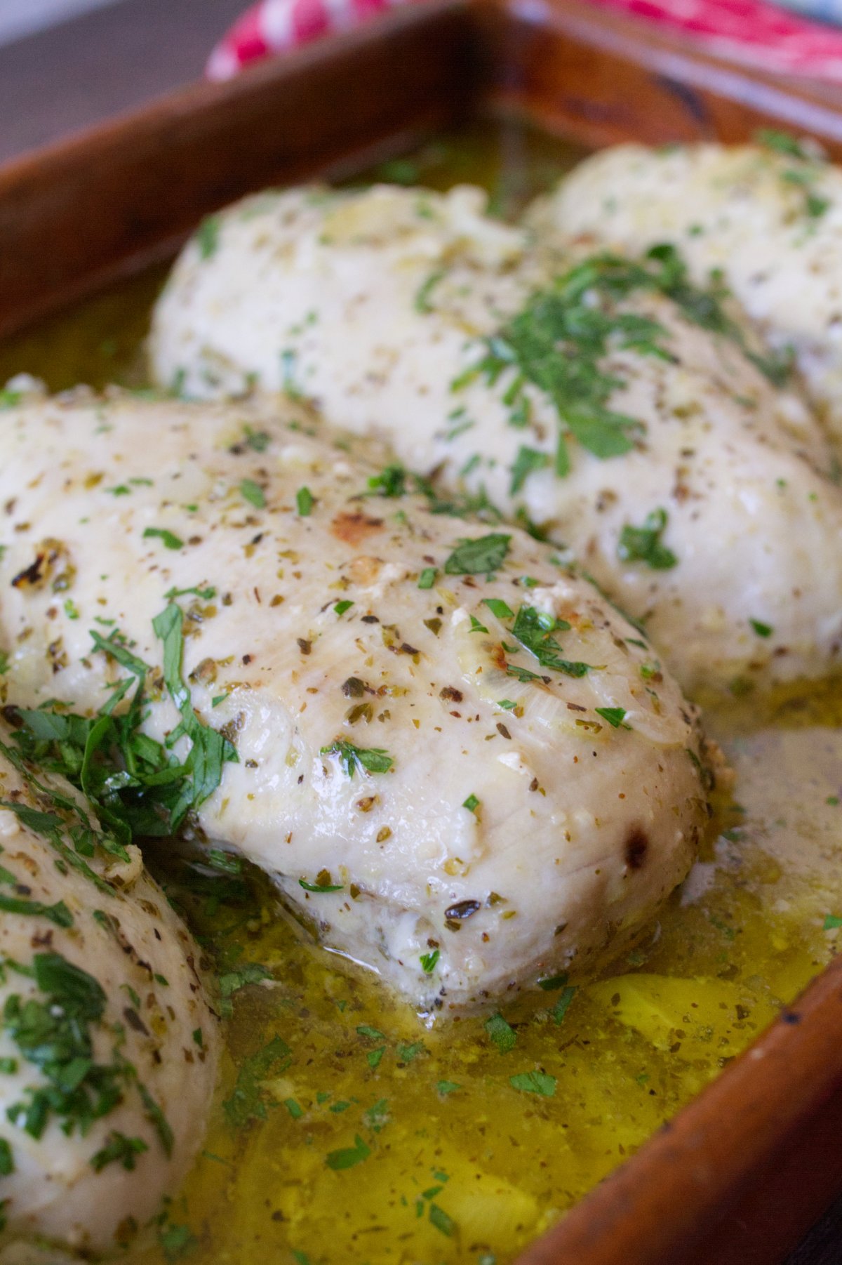 Mediterranean chicken breasts in a casserole dish.