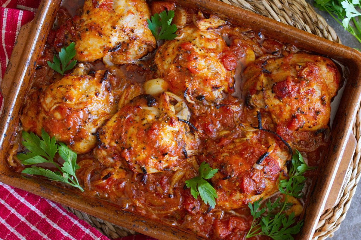 A large dish of Spanish-style chicken thighs