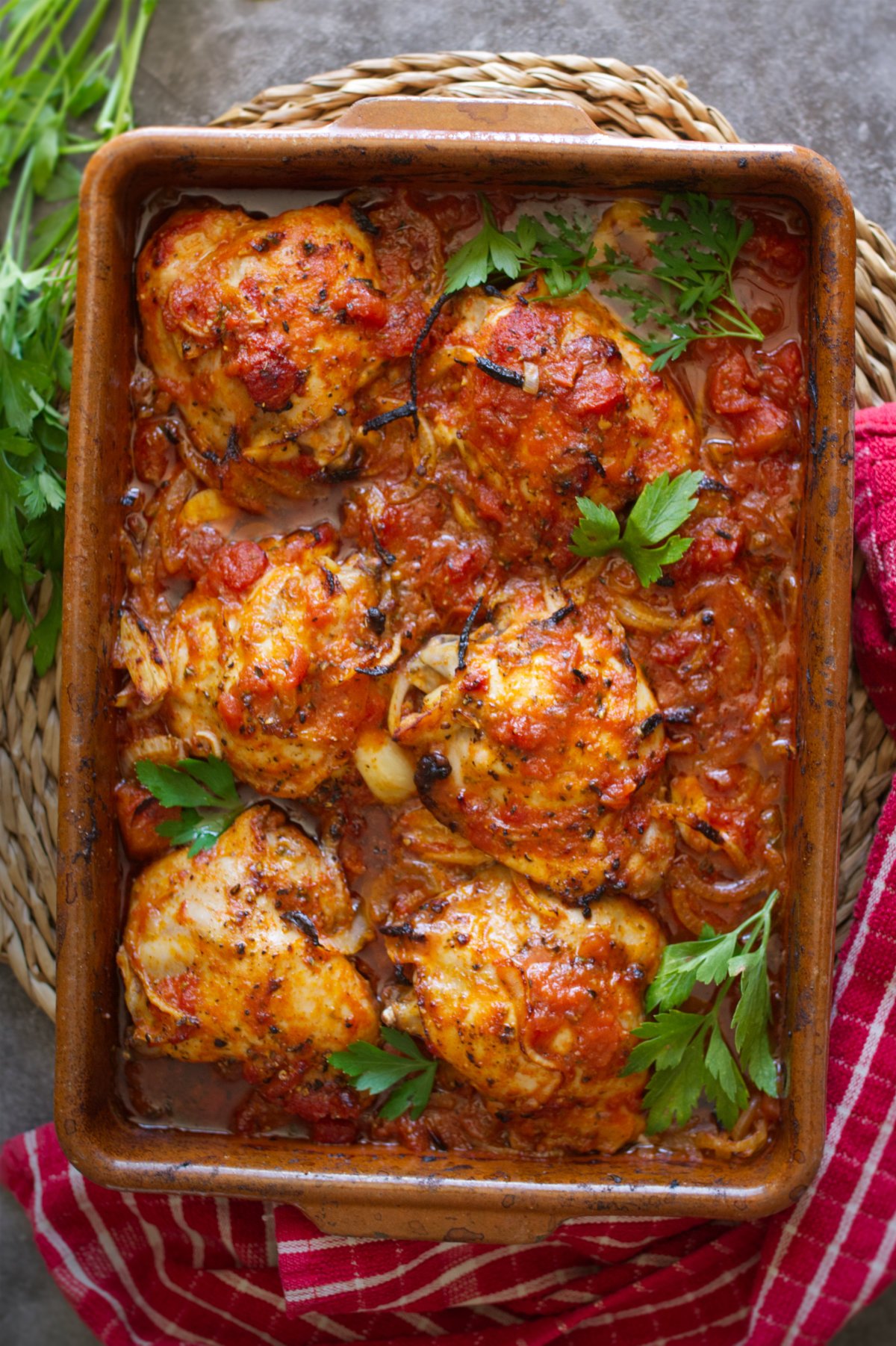 A large dish of Spanish-style chicken thighs