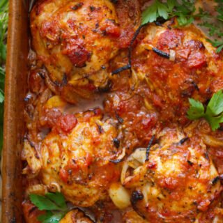 A large dish of Spanish-style chicken thighs