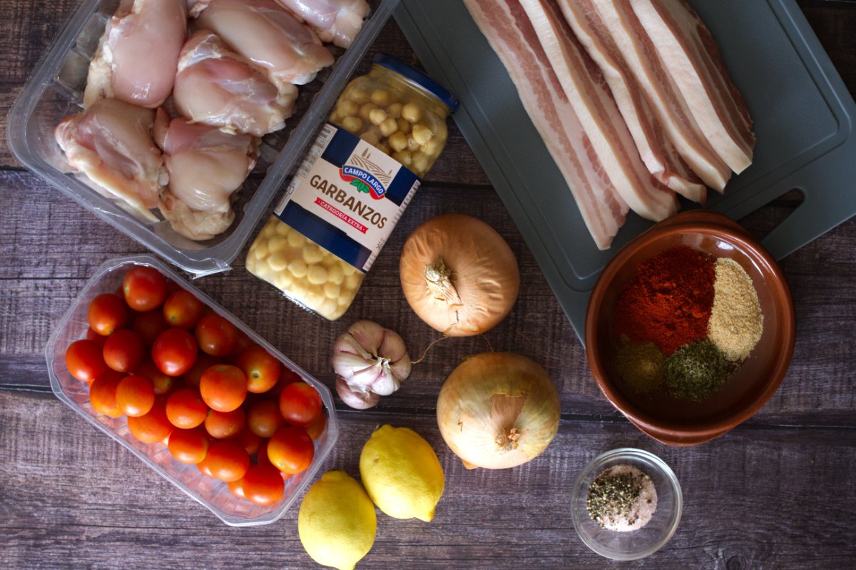 ingredients for making sheet pan baked chicken thighs sit on a counter. 