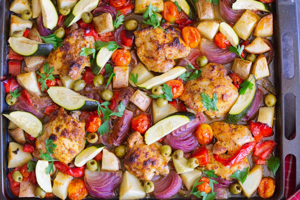 A large sheet pan of healthy Mediterranean Chicken thighs