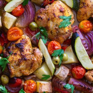 A large sheet pan of healthy Mediterranean Chicken thighs