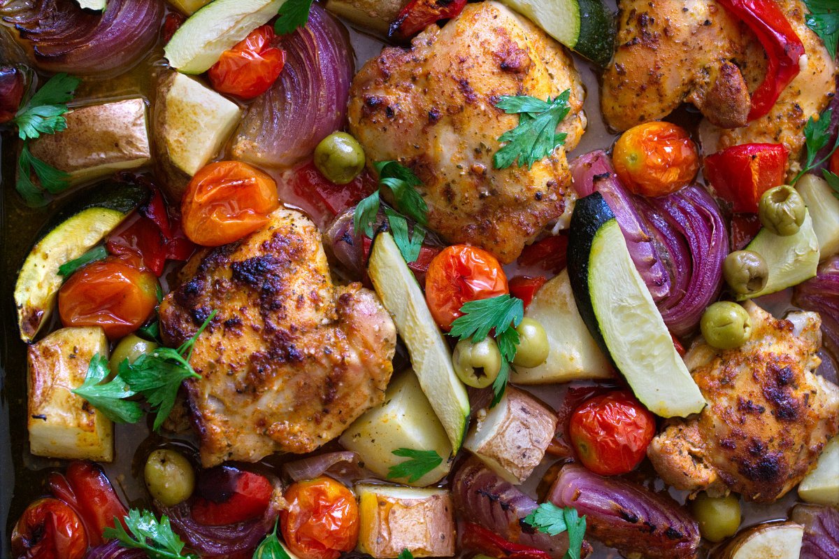 A large sheet pan of healthy Mediterranean Chicken thighs