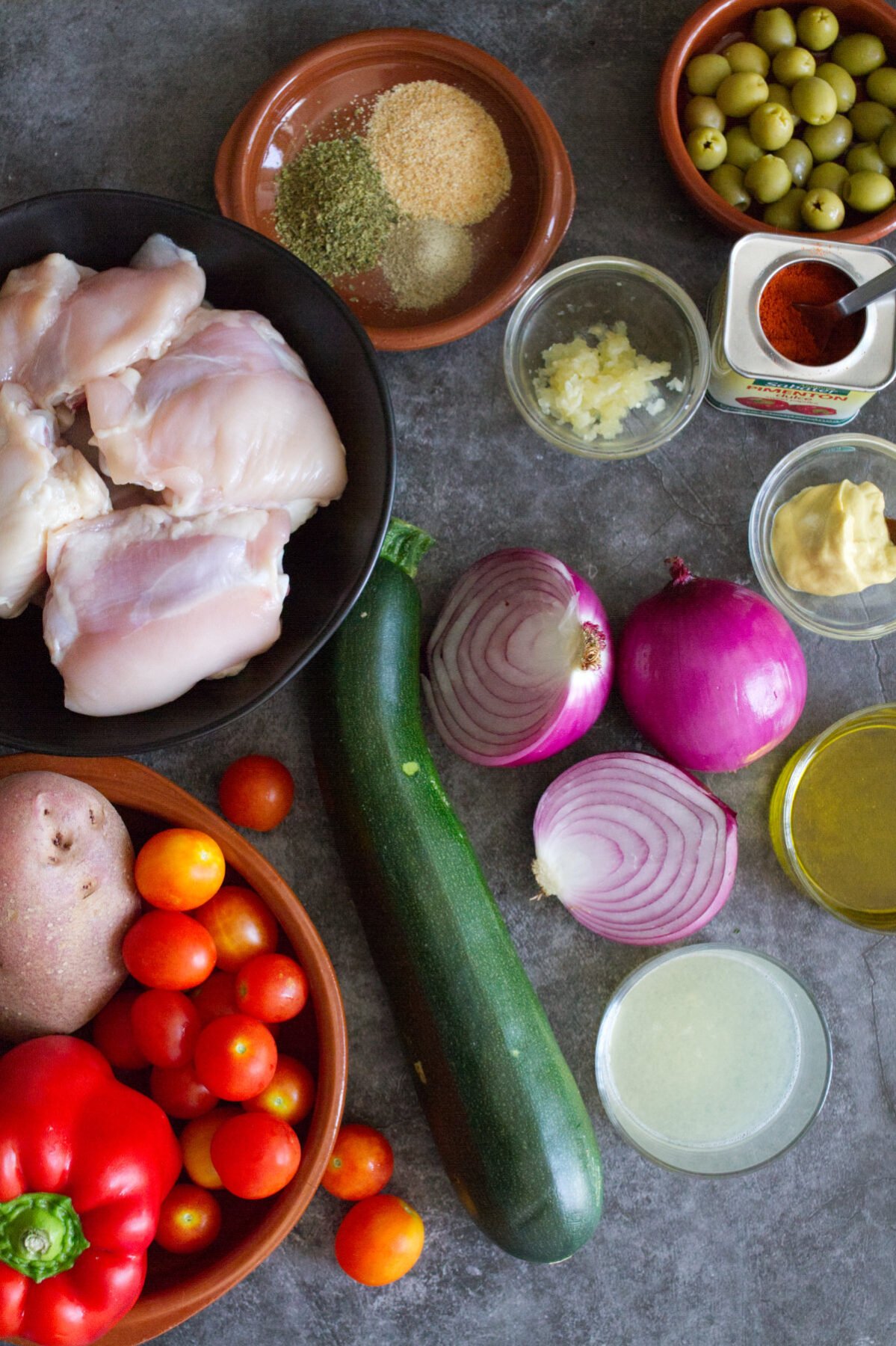 Ingredient used to make healthy baked Mediterranean chicken thighs sits on a kitchen counter. 