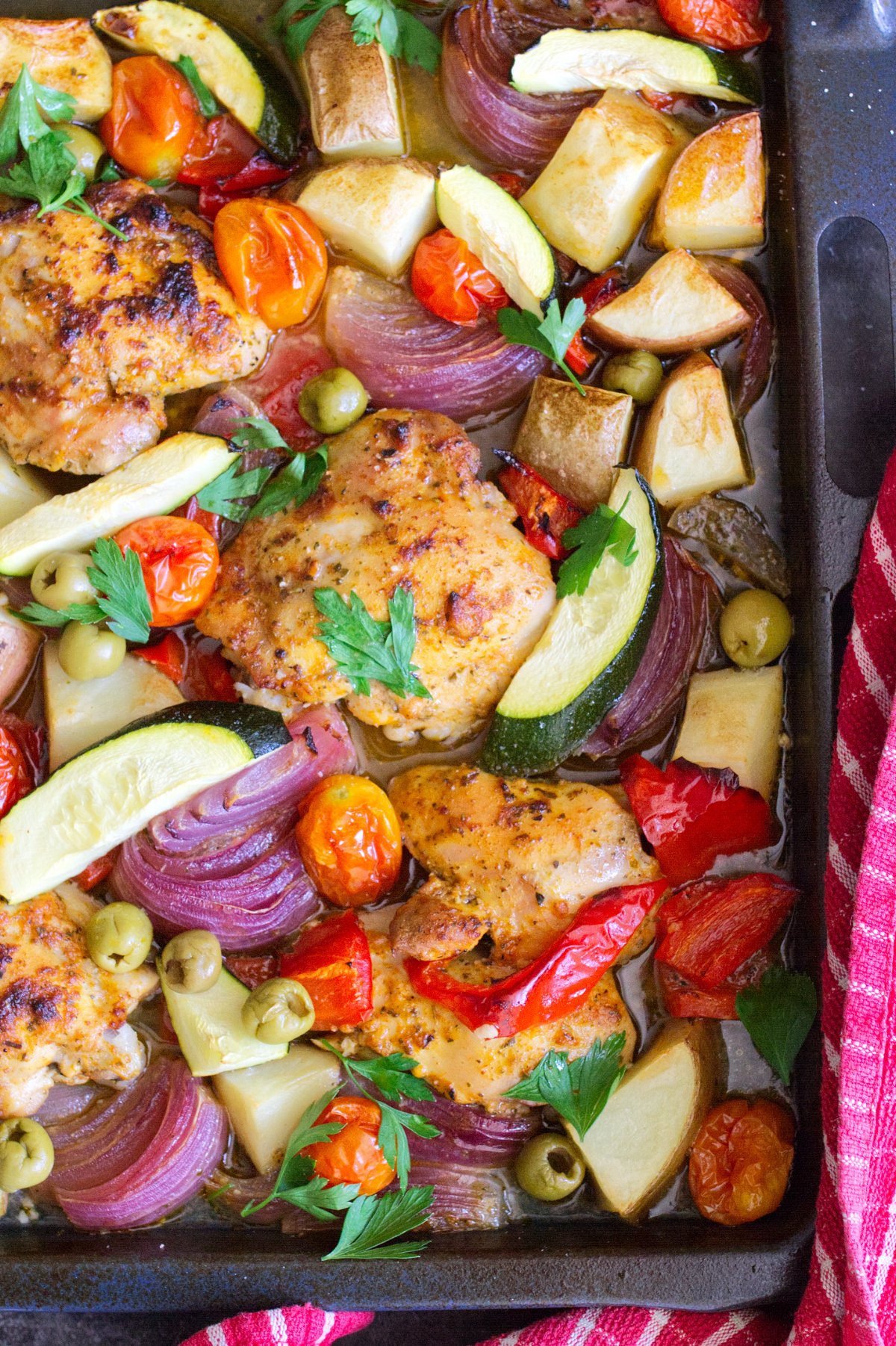 A large sheet pan of healthy Mediterranean Chicken thighs