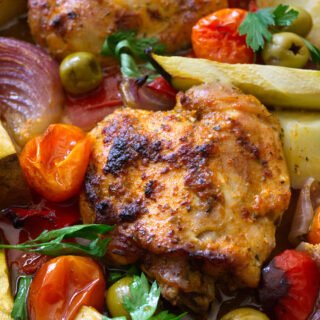 A large sheet pan of healthy Mediterranean Chicken thighs