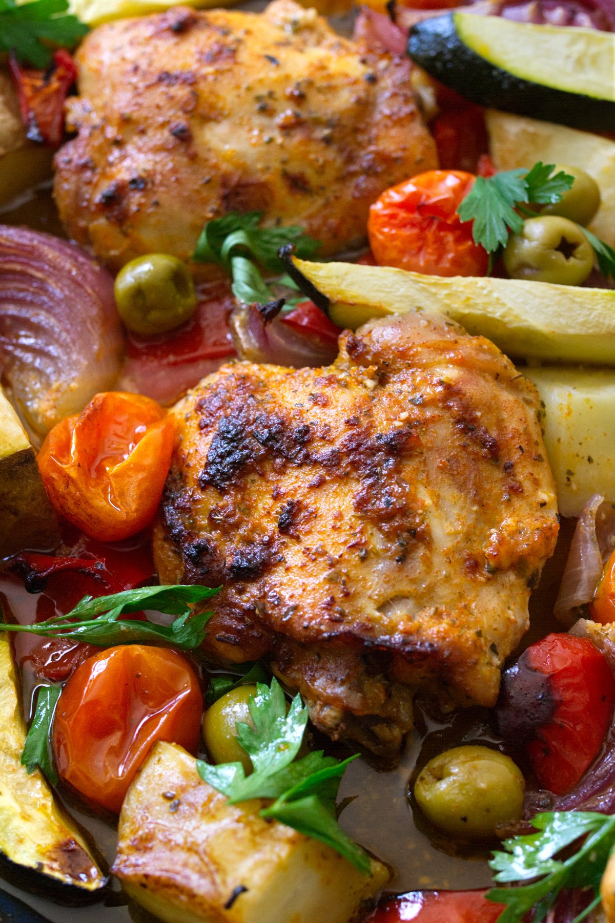 A large sheet pan of healthy Mediterranean Chicken thighs