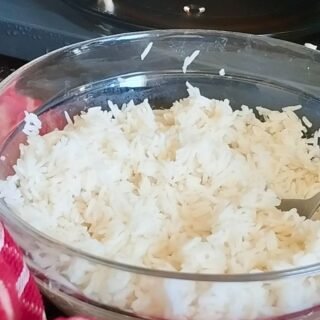 a bowl of white rice cooked in the microwave