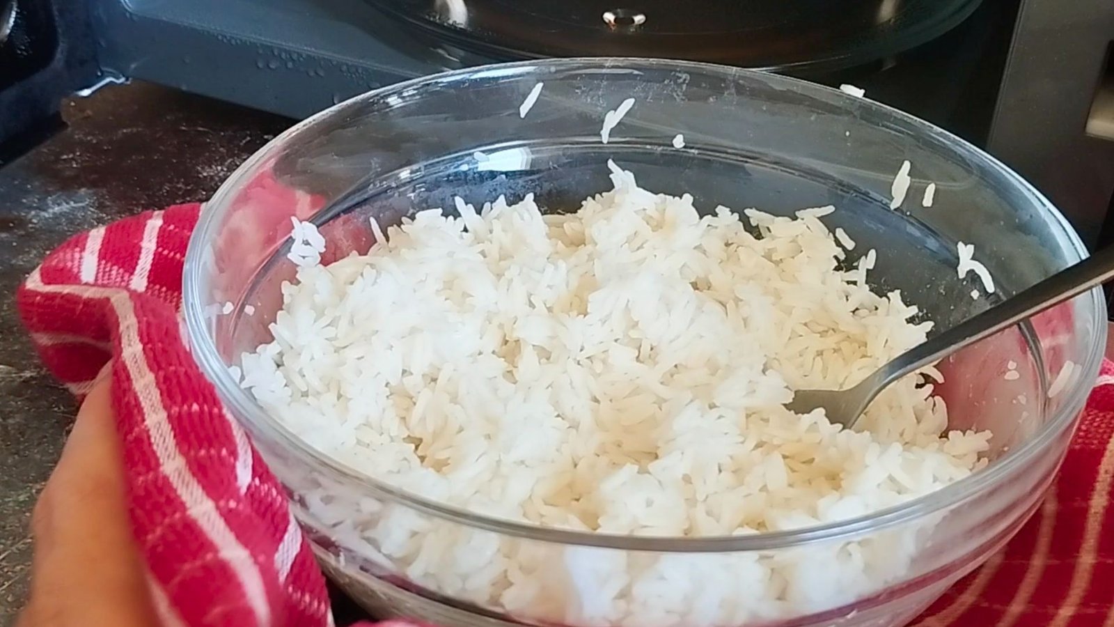 a bowl of white rice cooked in the microwave