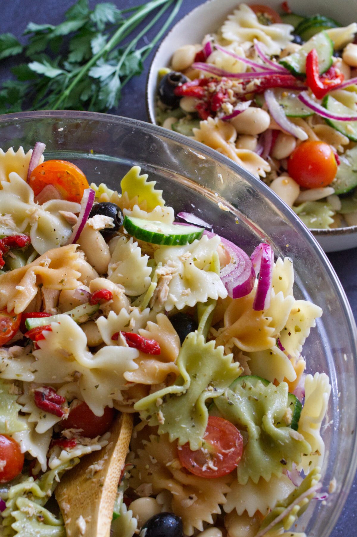 A large bowl of mediterranean pasta salad with tuna