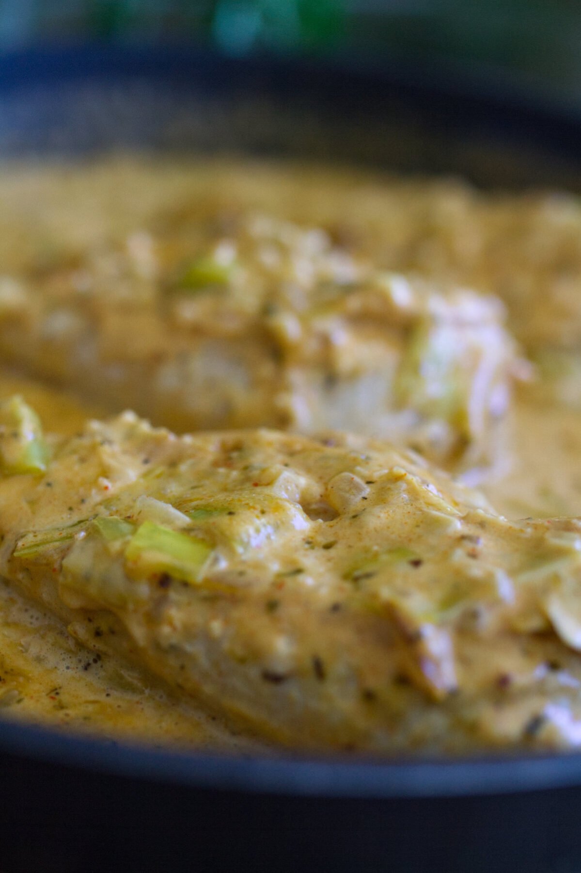 a pan of creamy garlic chicken with lots of sauce