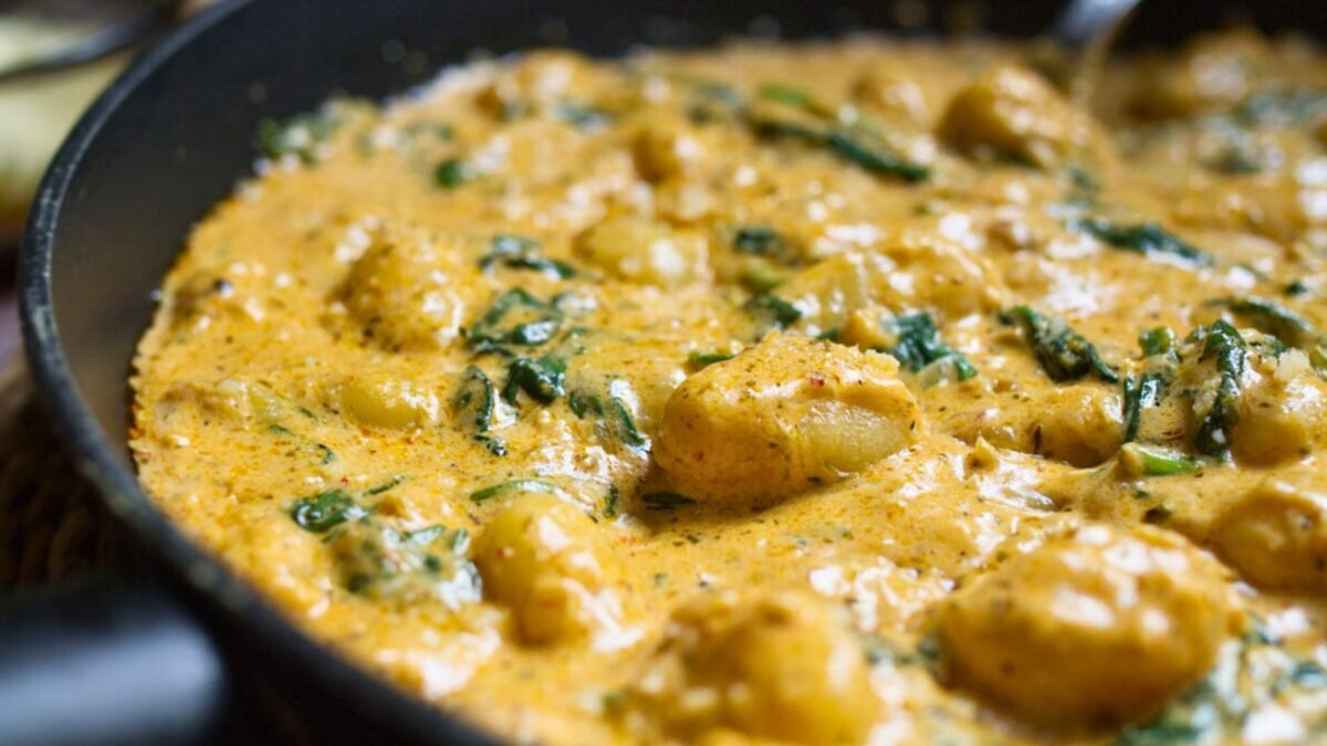 a large pan of creamy gnocchi with parmesan cheese.