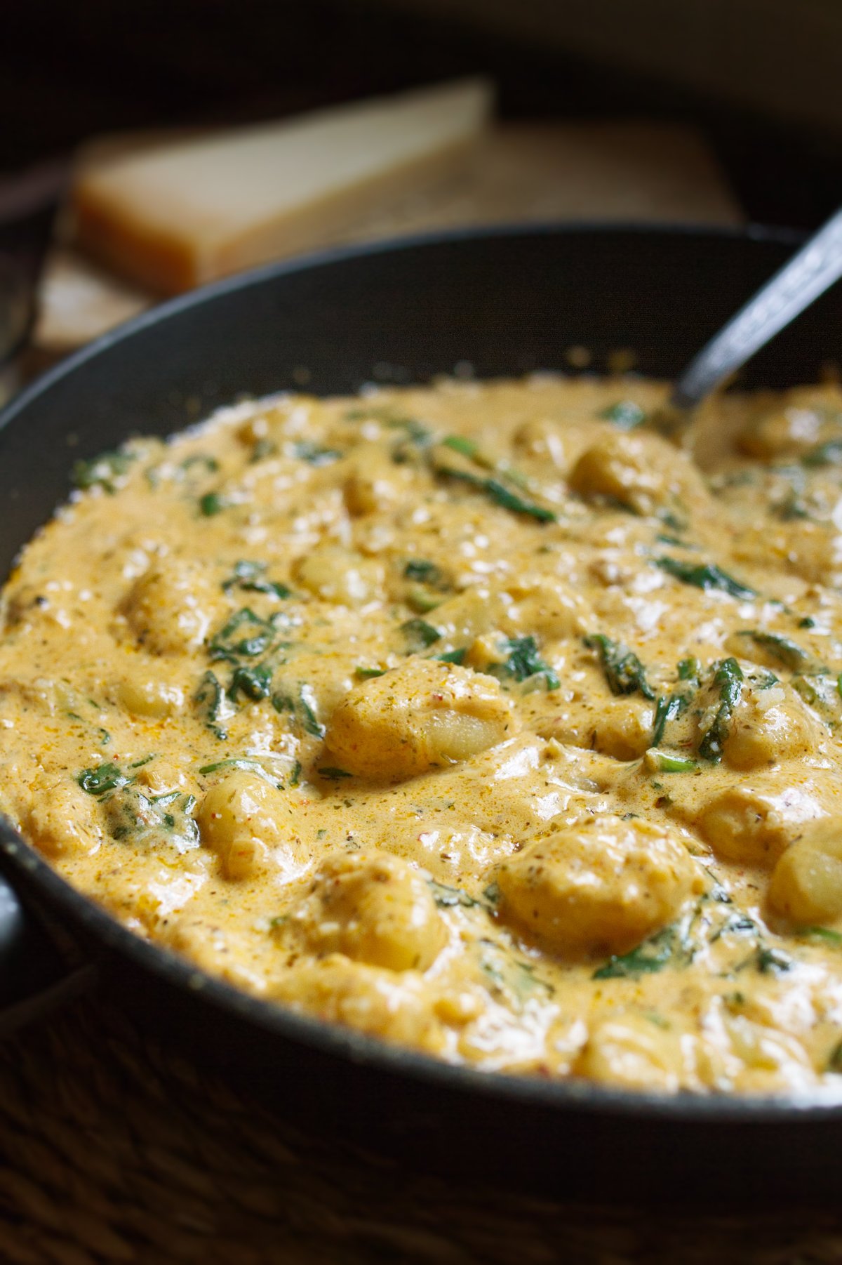 a large pan of creamy gnocchi with parmesan cheese.