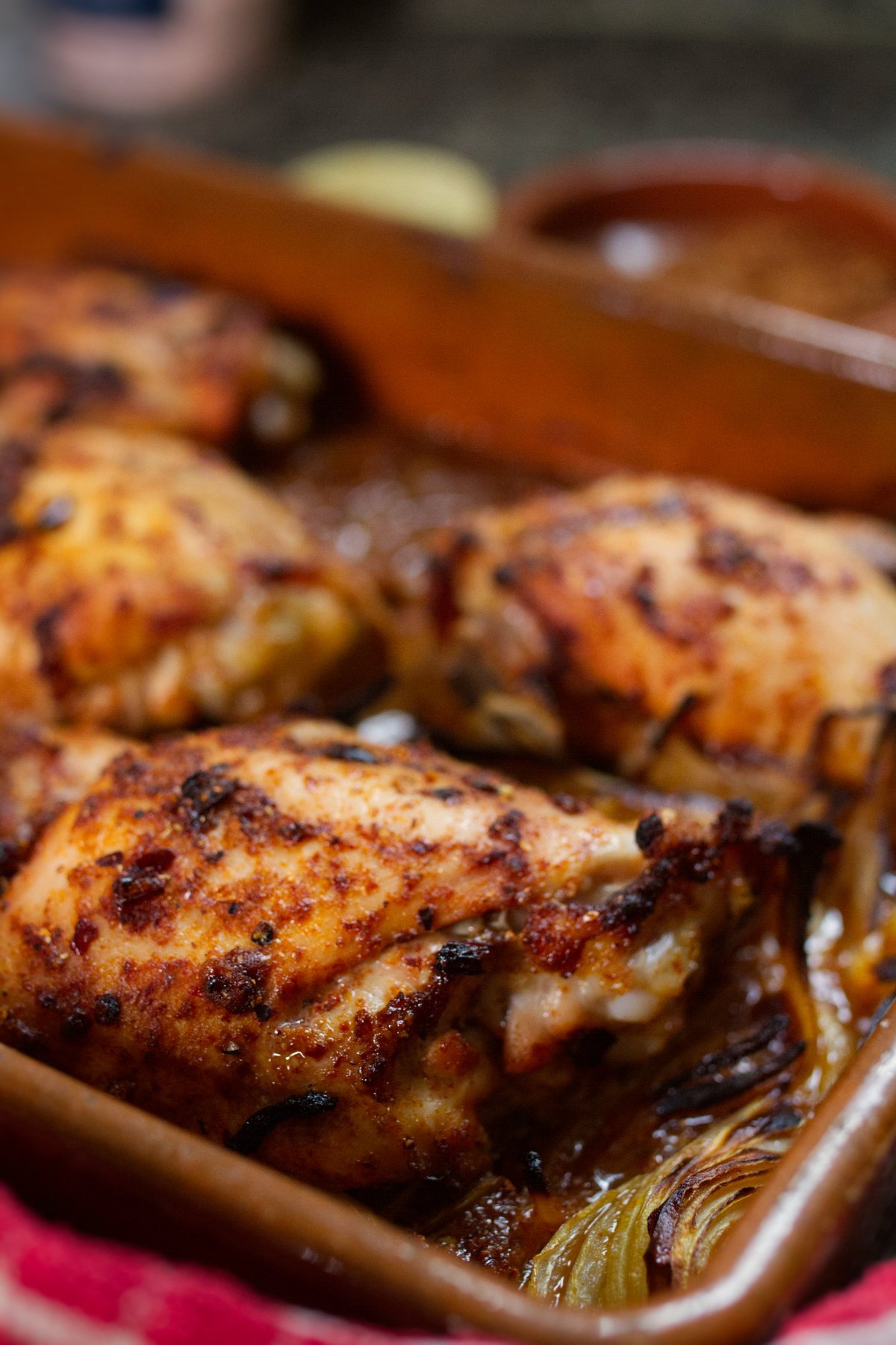 A large pan of cooked spicy Mediterranean chicken thighs