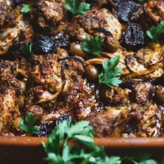 a large dish of za'atar chicken thighs with olives and prunes