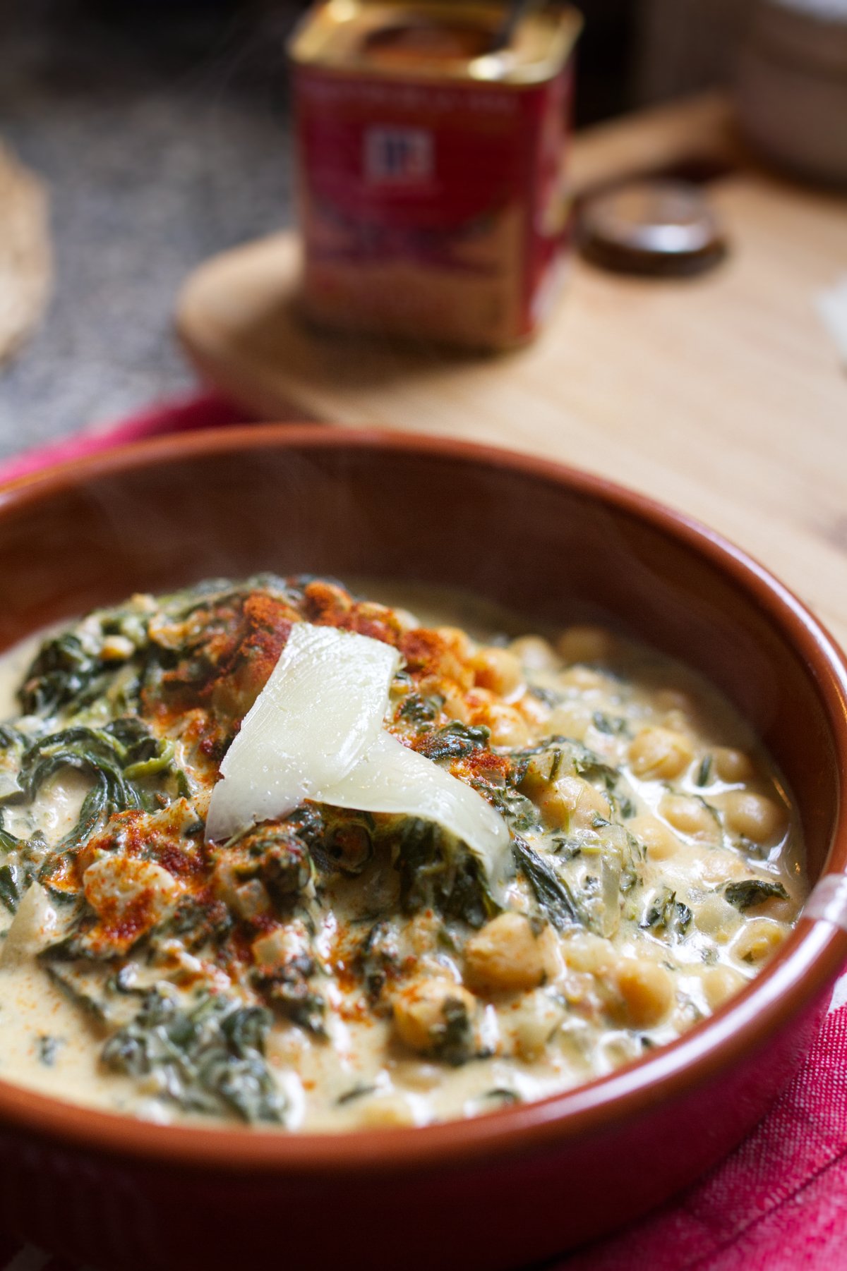 creamy-spinach-and-chickpeas-v2 - happymediterranean.com A bowl of creamy spinach and chickpeas with manchego cheese