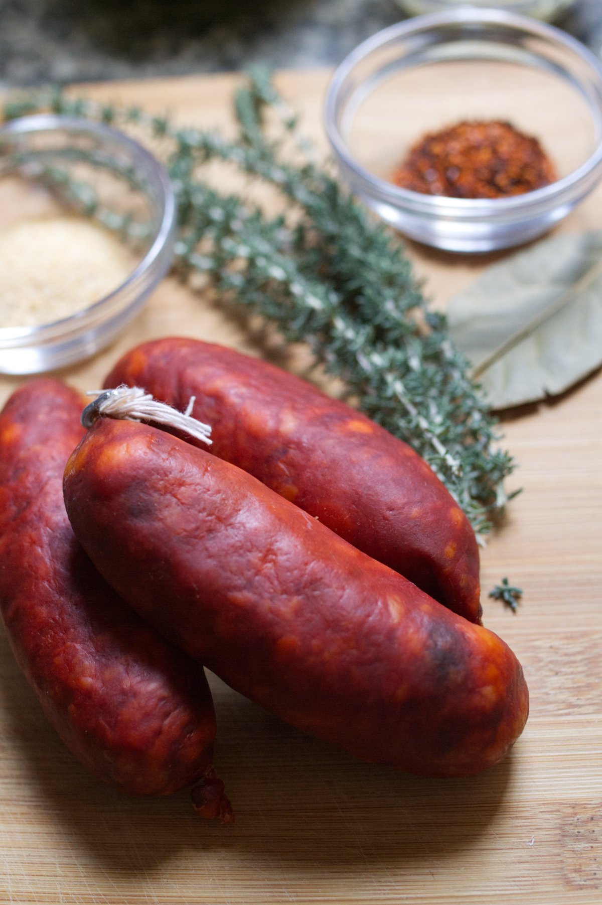chorizo - happymediterranean.com Fresh Spanish chorizo with some fresh herbs and bay leaves