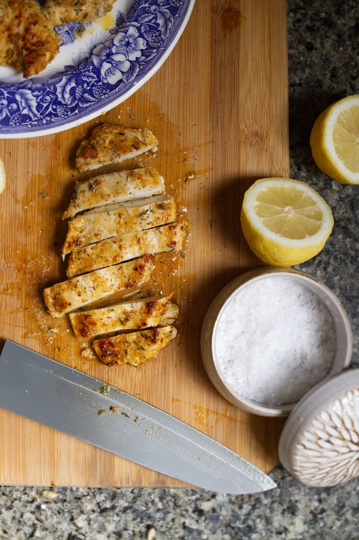 A marinated chicken breast a sliced on a chopping board