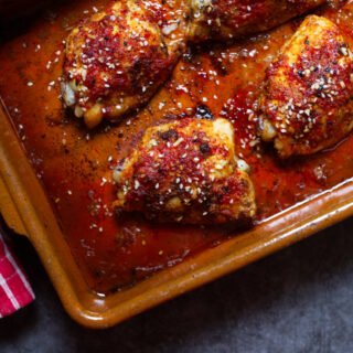 A pan of sweet and spicy harissa chicken thighs