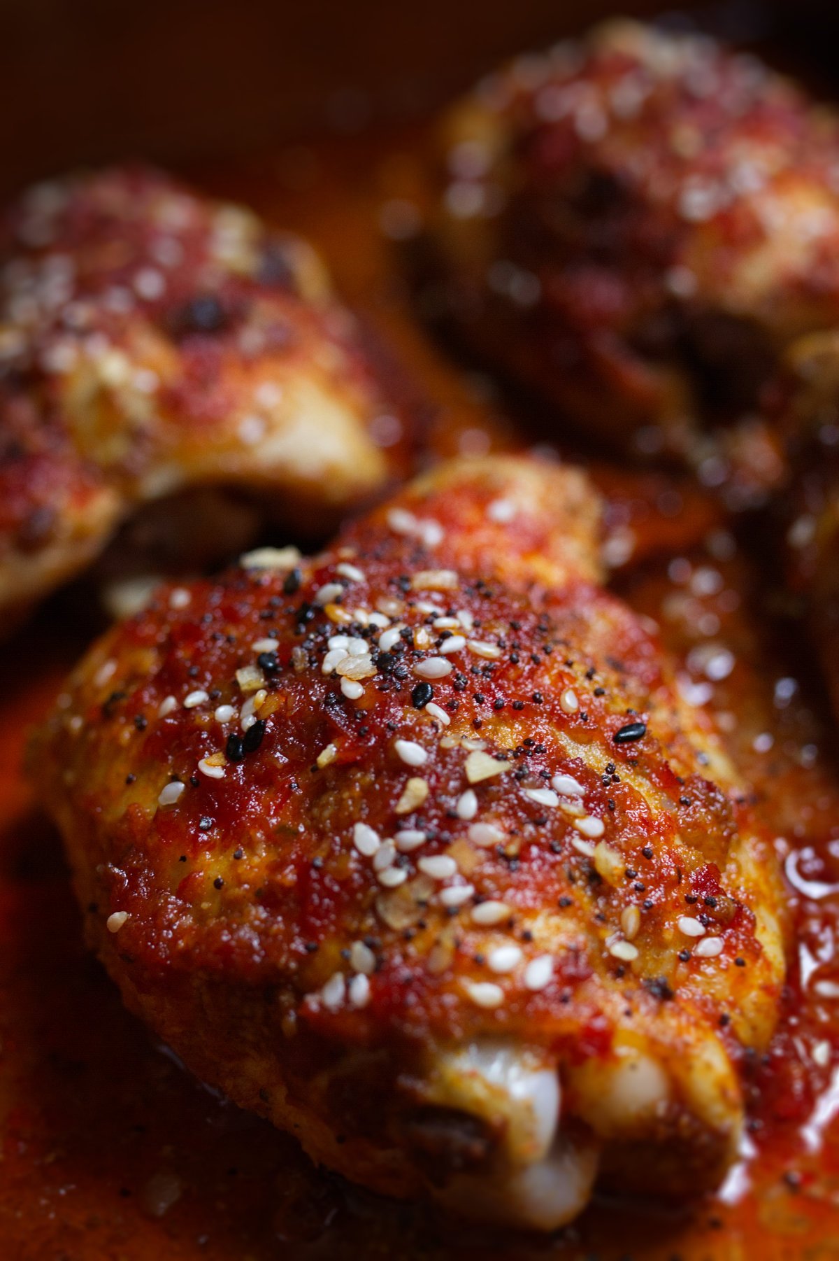 Spicy Harissa Honey Chicken Thighs-v20 - happymediterranean.com A pan of sweet and spicy harissa chicken thighs
