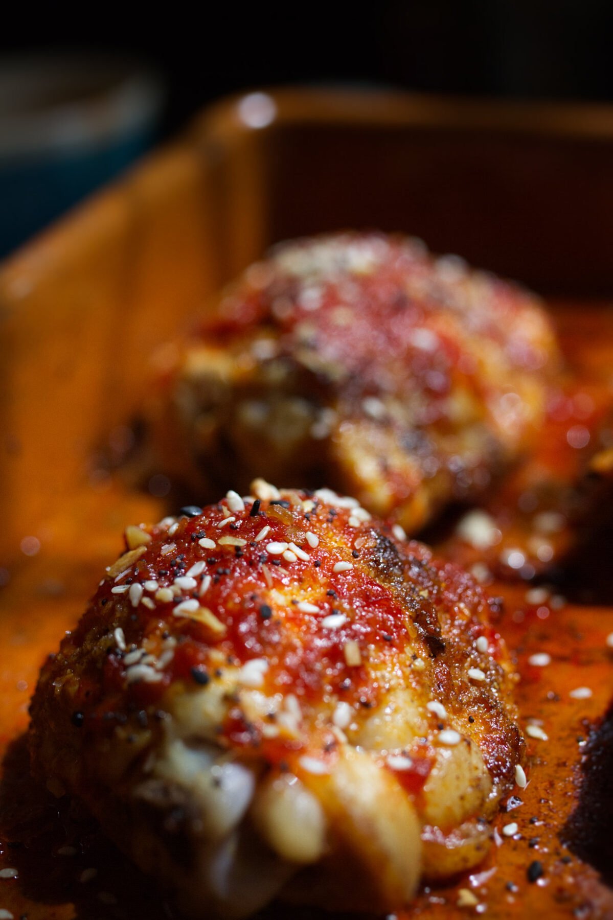 Spicy Harissa Honey Chicken Thighs-v25 - happymediterranean.com A pan of sweet and spicy harissa chicken thighs