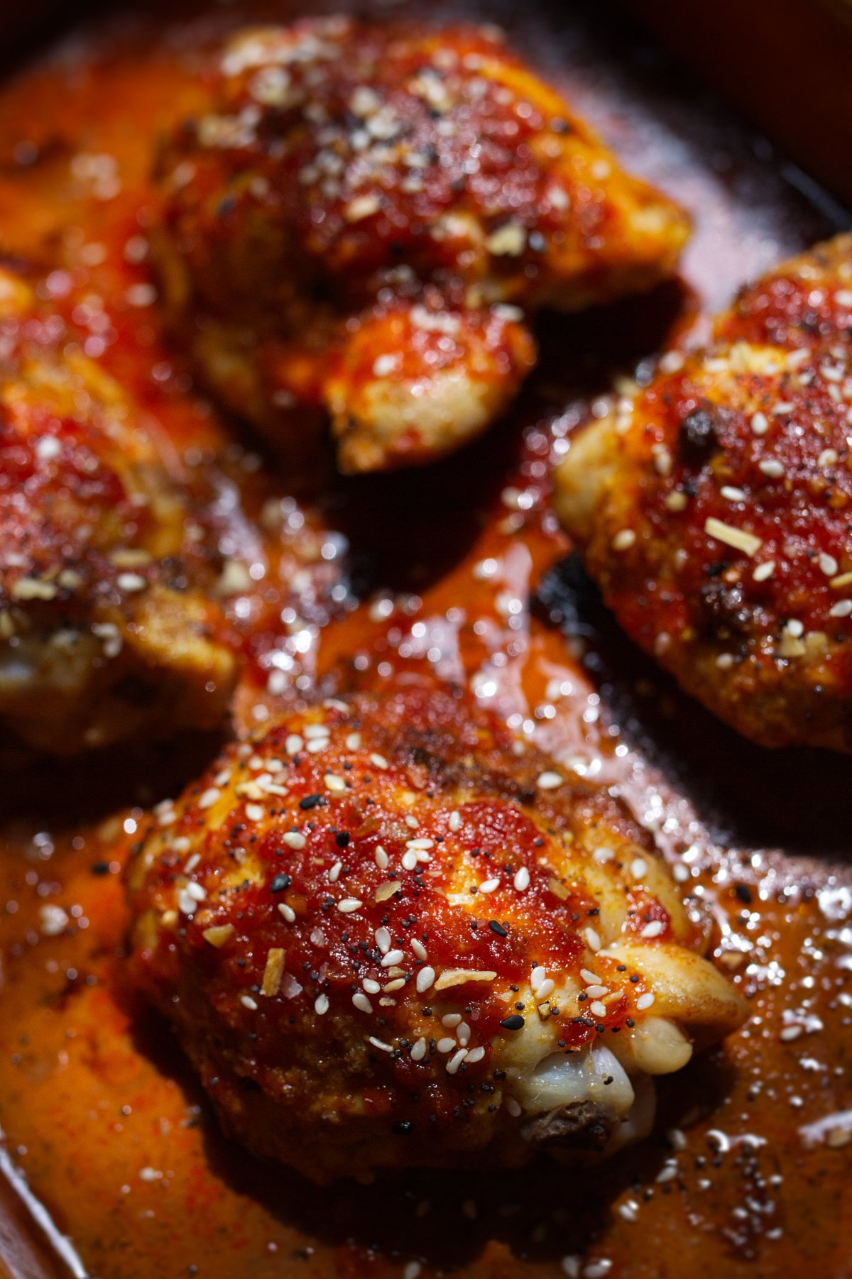 Spicy Harissa Honey Chicken Thighs-v26 - happymediterranean.com A pan of sweet and spicy harissa chicken thighs