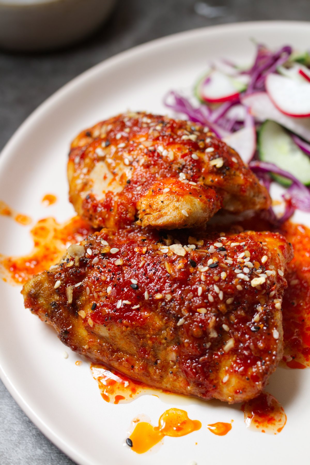 Spicy Harissa Honey Chicken Thighs-v3 - happymediterranean.com A pan of sweet and spicy harissa chicken thighs