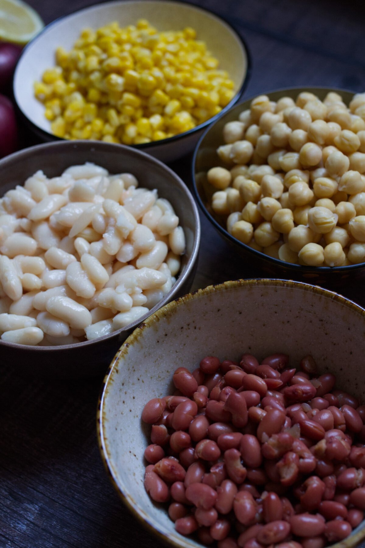Mediterranean-bean-salad-ing-v4 - happymediterranean.com kidney beans, butter beans, chickpeas, and corn in bowl
