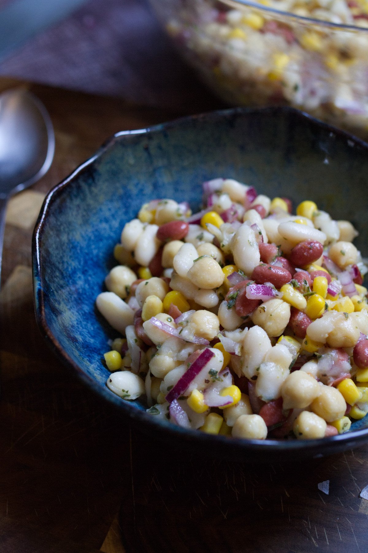 Mediterranean-bean-salad-v13 - happymediterranean.com A small bowl of Mediterranean bean salad