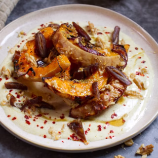 A plate of roasted butternut squash with dates and walnuts
