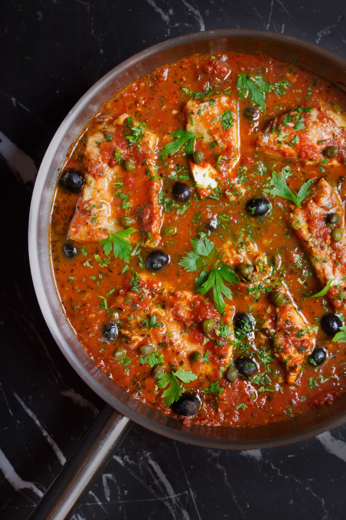 Fish Puttanesca-v11 - happymediterranean.com a large pan of Fish Puttanesca