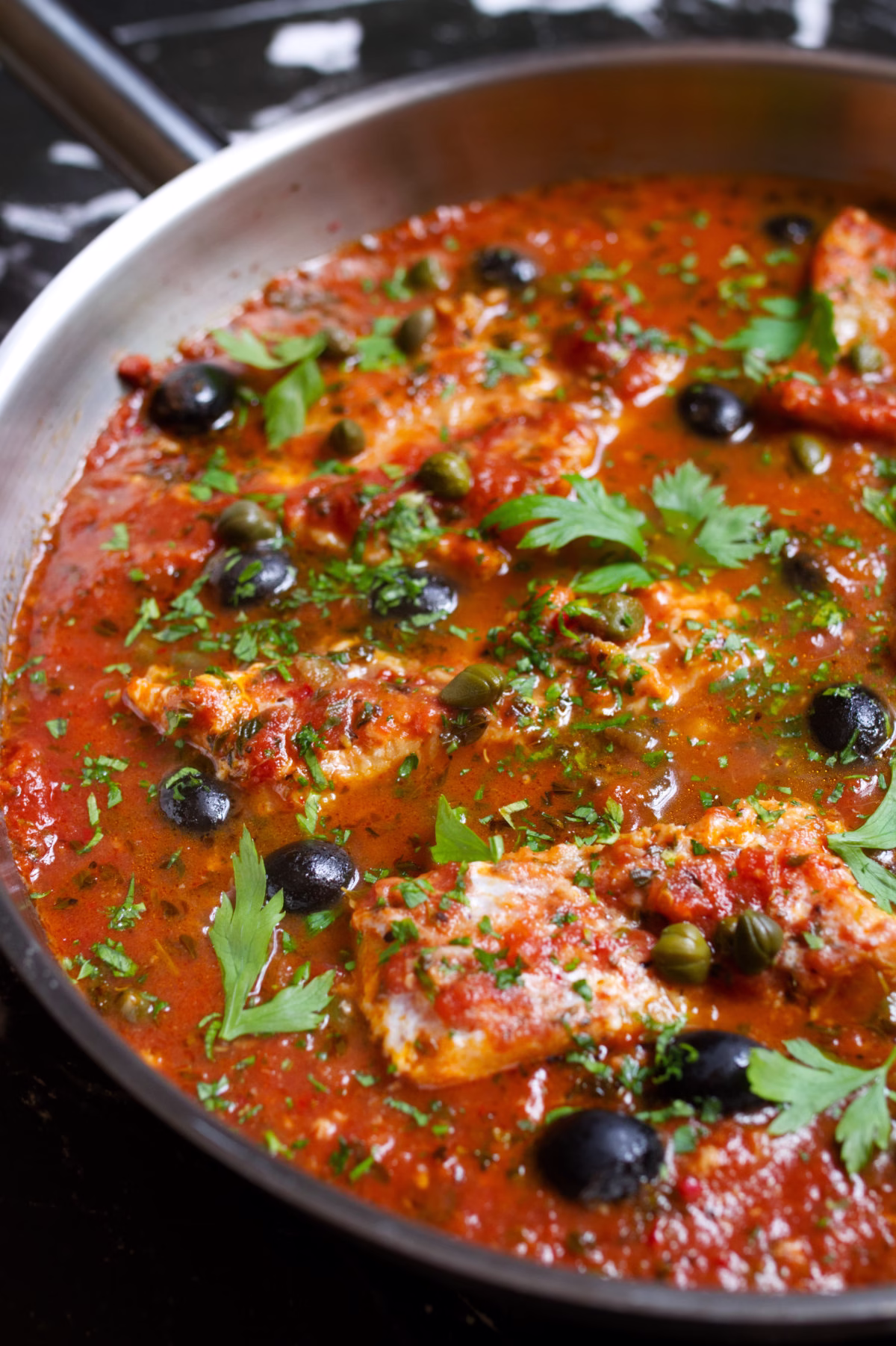 Fish Puttanesca-v12 - happymediterranean.com a large pan of Fish Puttanesca