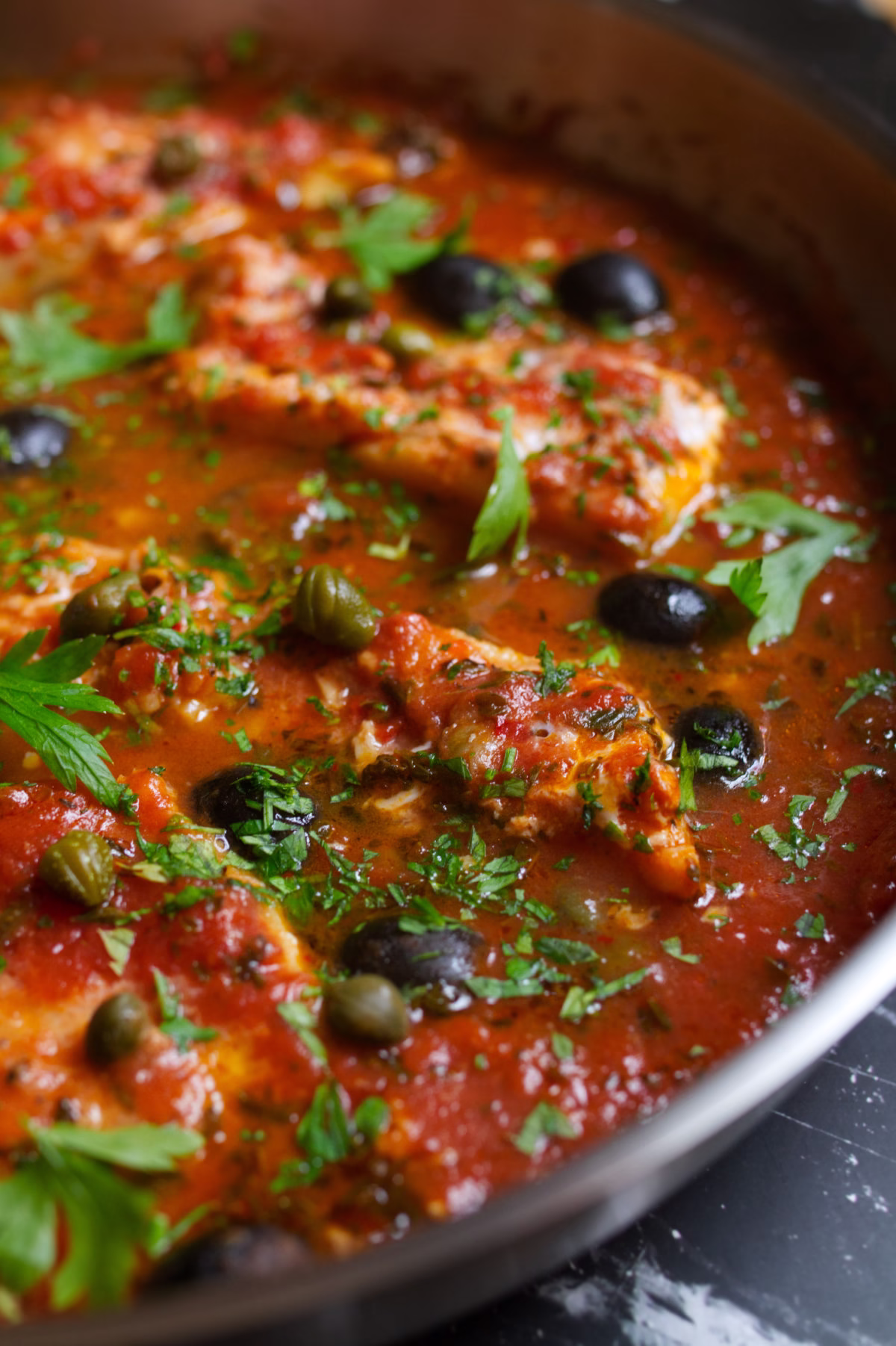 Fish Puttanesca-v6 - happymediterranean.com a large pan of Fish Puttanesca