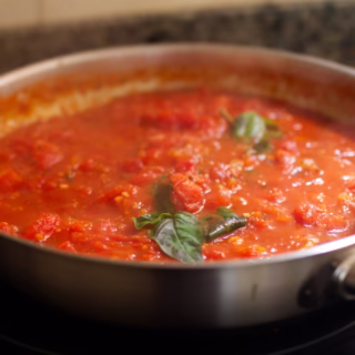 a pan of Napoletana sauce simmering away on a stovetop